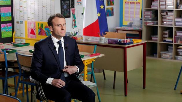 French President Emmanuel Macron arrives inside a classroom prior to attend an one-hour interview with French news channel TF1, at a school in Berd’huis, France, April 12, 2018.(REUTERS)