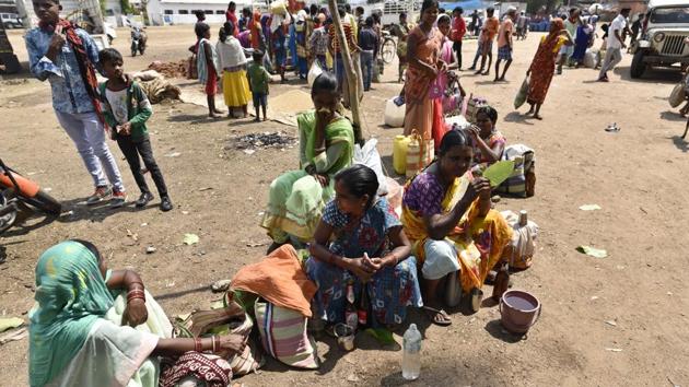 Tribal women seen selling the wine in a local marketplace in Dantewada district. An essential of any celebration among communities that revere the Mahua, the wine is enjoyed freely by men and women and is almost a part of winding down the day’s activities in the evening. (Sanchit Khanna / HT Photo)