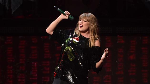 Police say a Connecticut man with a crush on singer Taylor Swift robbed a bank and then went to the pop star's Rhode Island mansion where he threw cash over a fence in an attempt to impress her.(Evan Agostini/Invision/AP)