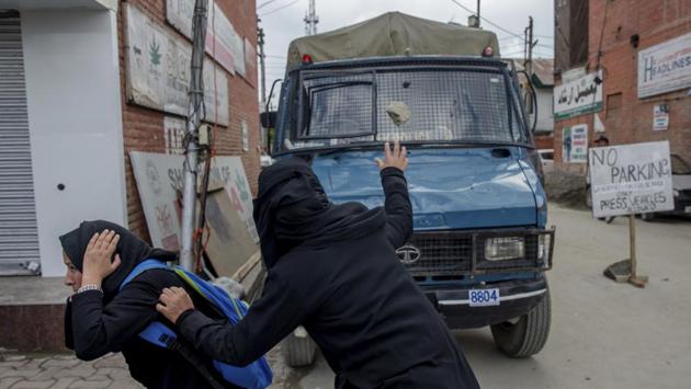 A burqa clad student, throws stone at a police vehicle during a protest against the killing of civilians in Srinagar, Kashmir on April 11, 2018. Three men were killed in Kashmir when forces fired on protesters who thronged a village following a gun battle that killed three rebels and a soldier. (Dar Yasin / AP) A burqa clad student, throws stone at a police vehicle during a protest against the killing of civilians in Srinagar, Kashmir on April 11, 2018. Three men were killed in Kashmir when forces fired on protesters who thronged a village following a gun battle that killed three rebels and a soldier. (Dar Yasin / AP)