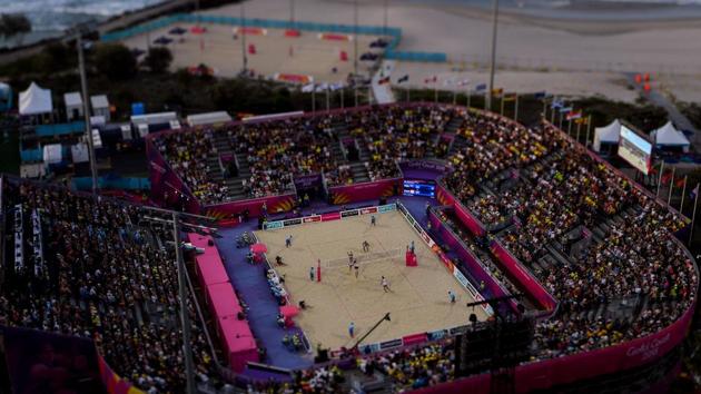 A tilt and shift image shows Ben O'dea and Sam O'dea of New Zealand (top) competing against Samuel Pedlow and Sam Schachter of Canada during their men's beach volleyball semi-final match at the Coolangatta beachfront on April 11, 2018. (Manan Vatsyayana / AFP)
