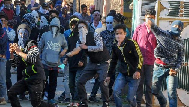 Youth throw stones at police during clashes with security forces on Thursday following a protest over the deaths of civilians at Kulgam in Jammu and Kashmir.(PTI)