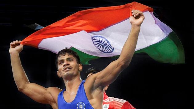 Rahul Aware holds tricolour after winning the match against Canada's Steven Takahashi in the men's freestyle 57kg wrestling final at the Commonwealth Games 2018 in Gold Coast on Thursday.(PTI)