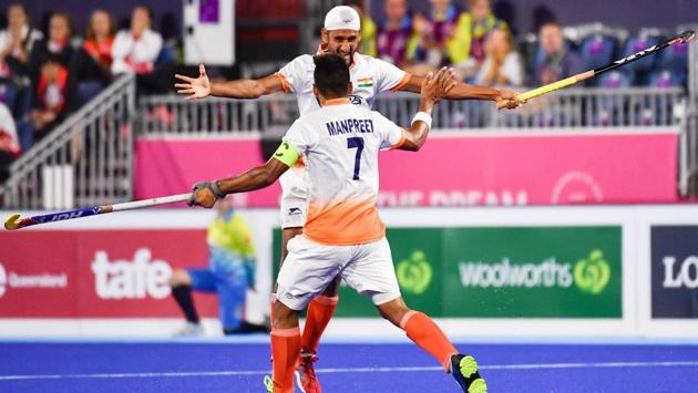 India’s Mandeep Singh (back) and Manpreet Singh celebrate a goal during the men's field hockey match between England and India on April 11, 2018. (Anthony Wallace / AFP)