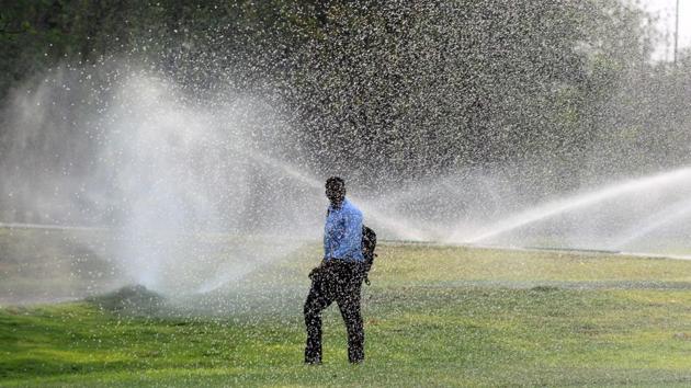 A man walks past a golf course as sprinklers keep the lawn at Poona Golf Course wet on April 10. (SHANKAR NARAYAN/HT PHOTO) A man walks past a golf course as sprinklers keep the lawn at Poona Golf Course wet on April 10. (SHANKAR NARAYAN/HT PHOTO)