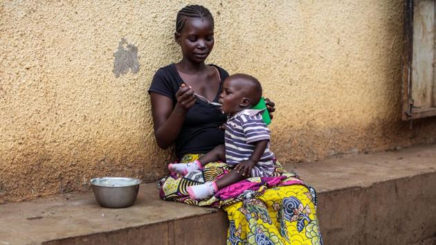 A refugee from the DRC feeds her child at the Kagoma reception centre. Starving children are the glaring face of Congo’s humanitarian crisis, but millions more are suffering slow onset malnutrition which could have harmful effects for generations to come. (Jack Taylor / Getty Images)