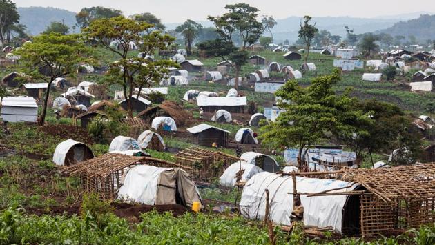 Shelters for refugees stand on a hill in the Kyangwali Refugee Settlement. People are sleeping back-to-back in makeshift hangars as reception centres along the shore of the lake are overwhelmed, according to Medecins Sans Frontieres, which said the risk of a measles outbreak in the camps is also high. (Jack Taylor / Getty Images)