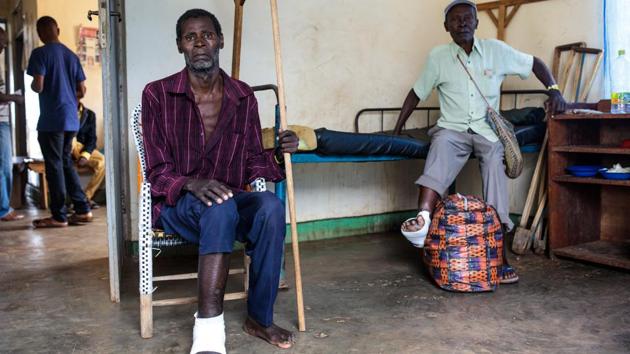 Two refugees who injured their feet fleeing are pictured in a ward at the Rwenyawawa Health Centre in the refugee settlement. Hema and Lendu groups have a long history of violence but in the late 90s and early 2000s their fight became a broader, brutal battle stoked by Rwanda and Uganda, seeking gold, diamond and timber along with influence in a wider war that played out in the DRC. (Jack Taylor / Getty Images)