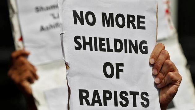 People hold placards at a protest against the rape of an eight-year-old girl, in Kathua, near Jammu and a teenager in Unnao, Uttar Pradesh, in New Delhi.(Reuters Photo)