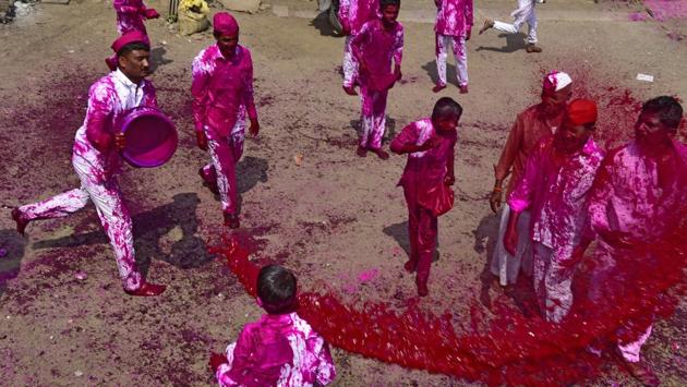 People drenched with coloured water during an important and famous annual festival of God bhairavnath at Surur village, Wai, Satara district in Maharashtra on April 07, 2018. Every year a devotee is chosen for this spiritual ritual, who is hung at the top of a bagad for a whole day till it completes its 5 kilometers journey. The bagad with an estimated height of 30-40 feet is commuted with the help of atleast 6 bullocks. (Vijayanand Gupta / HT Photo) People drenched with coloured water during an important and famous annual festival of God bhairavnath at Surur village, Wai, Satara district in Maharashtra on April 07, 2018. Every year a devotee is chosen for this spiritual ritual, who is hung at the top of a bagad for a whole day till it completes its 5 kilometers journey. The bagad with an estimated height of 30-40 feet is commuted with the help of atleast 6 bullocks. (Vijayanand Gupta / HT Photo)