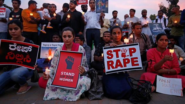 People participate in a candle light vigil as they protest against the rape of an eight-year-old girl in Kathua near Jammu, and a teenager in Uttar Pradesh’s Unnao, in Bengaluru, on February 15, 2018.(Reuters)