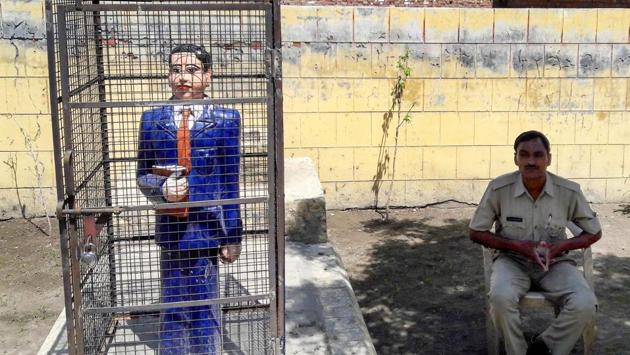 A statue of Dr Bhimrao Ambedkar locked in an iron cage in Badaun on Thursday.(PTI FILE PHOTO)