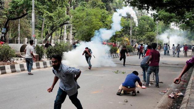 Bangladeshi students run for cover after policemen fire tear gas as they protest demanding the removal or reforms for a quota system in government jobs in Dhaka, Bangladesh. (A. M. Ahad / AP) Bangladeshi students run for cover after policemen fire tear gas as they protest demanding the removal or reforms for a quota system in government jobs in Dhaka, Bangladesh. (A. M. Ahad / AP)