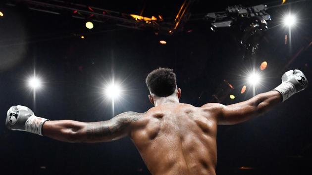 France's Tony Yoka celebrates after defeating France's Cyril Leonet in their heavyweight boxing match at the Palais des Sports in Paris, France. (Christophe Simon / AFP) France's Tony Yoka celebrates after defeating France's Cyril Leonet in their heavyweight boxing match at the Palais des Sports in Paris, France. (Christophe Simon / AFP)
