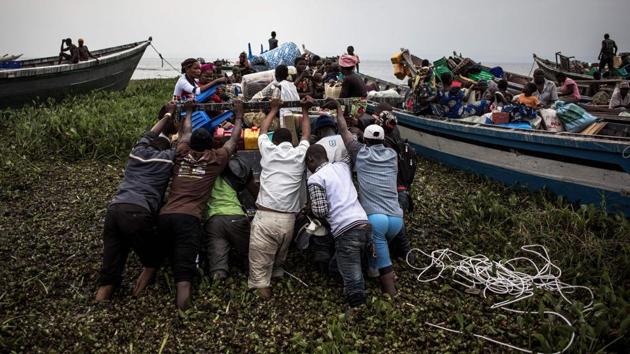 Internally displaced Congolese push a boat out to Lake Albert. Fighting in DRC between the Hema and Lendu communities has seen villages burnt and dozens killed in the latest outbreak of violence, forcing Congolese to flee to refugee camps in Uganda. The United Nations refugee agency UNHCR expects at least 200,000 refugees to reach Uganda from Congo’s Ituri region this year. (John Wessels / AFP)