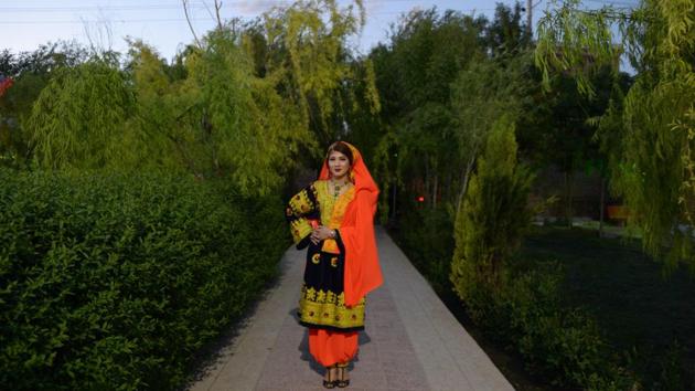 An Afghan model prepares to go on stage at the first Afghan cultural fashion show at an amusement park in Mazar-i-Sharif, Afghanistan. (Farshad Usayn / AFP) An Afghan model prepares to go on stage at the first Afghan cultural fashion show at an amusement park in Mazar-i-Sharif, Afghanistan. (Farshad Usayn / AFP)