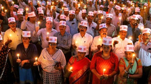 Members of Samanya Pichhda Alpsankhayak Kalyan Samaj light candles during a condolence meeting to pay tribute to the people killed in protests against the alleged dilution of the SC/ST Act during Bharat Bandh, in Bhopal, on April 7, 2018.(PTI File Photo) Members of Samanya Pichhda Alpsankhayak Kalyan Samaj light candles during a condolence meeting to pay tribute to the people killed in protests against the alleged dilution of the SC/ST Act during Bharat Bandh, in Bhopal, on April 7, 2018.(PTI File Photo)