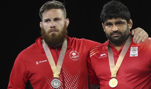 India's gold medallist in men's freestyle 125kg wrestling,Sumit Kumar (R), admitted to biting his opponent - Canada's silver medallist Korey Jarvis - in their bout at the 2018 Commonwealth Games in Gold Coast on Saturday.(AP) India's gold medallist in men's freestyle 125kg wrestling,Sumit Kumar (R), admitted to biting his opponent - Canada's silver medallist Korey Jarvis - in their bout at the 2018 Commonwealth Games in Gold Coast on Saturday.(AP)