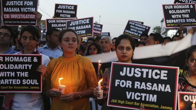 Lawyers participate in a candle light procession in protest against the rape and murder of an 8-year-old girl, in Jammu on Saturday.(AP Photo)