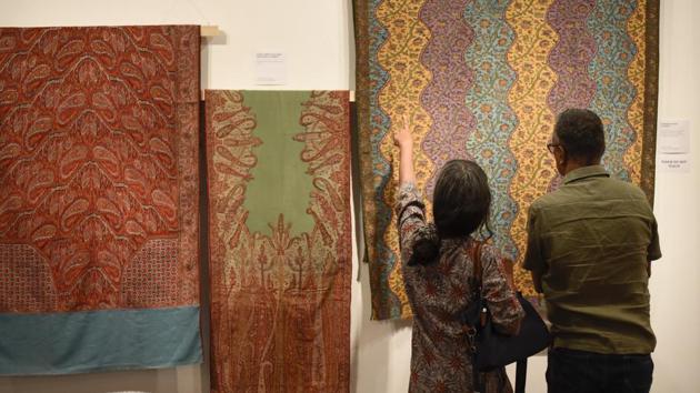 Visitors look at the details of the shawl exhibited at IIC, Delhi. Ritu Sethi (not pictured) chairman, Craft Revival Trust said, “Among all the ancient textiles that are available, the largest collection is that of shawls. And shawls were not possible without rafoogars. They are the ones responsible for maintaining and preserving these marvellous pieces.” (Burhaan Kinu / HT Photo) Visitors look at the details of the shawl exhibited at IIC, Delhi. Ritu Sethi (not pictured) chairman, Craft Revival Trust said, “Among all the ancient textiles that are available, the largest collection is that of shawls. And shawls were not possible without rafoogars. They are the ones responsible for maintaining and preserving these marvellous pieces.” (Burhaan Kinu / HT Photo)