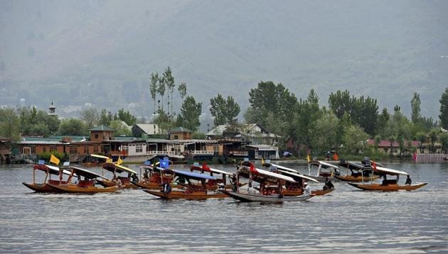 Boatmen row their boats during Shikara Festival at Dal Lake in Srinagar .(PTI File Photo)