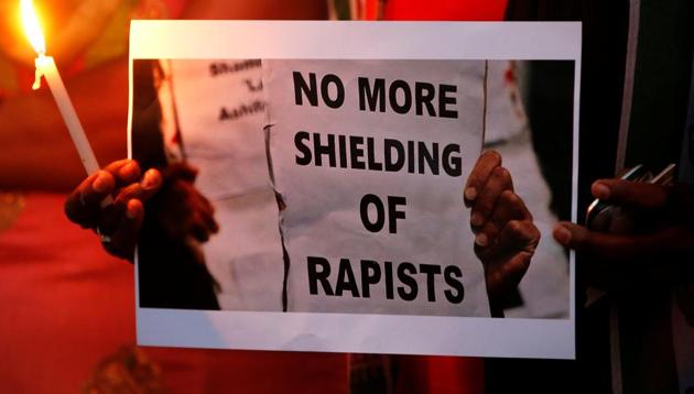 People carry placards demanding justice in the Kathua and Unnao rape cases, in Ahmedabad on April 13, 2018.(Reuters)