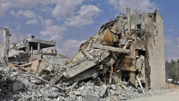 This picture taken on April 14, 2018 shows the wreckage of a building described as part of the Scientific Studies and Research Centre (SSRC) compound in the Barzeh district, north of Damascus, during a press tour organised by the Syrian information ministry.(AFP)