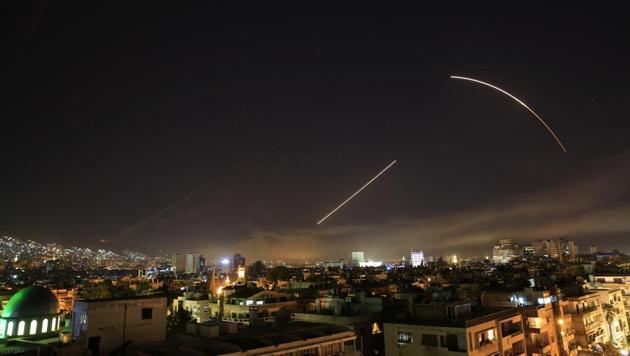 Missiles streak across the Damascus skyline as the US launches an attack on Syria targeting different parts of the capital.(AP Photo)
