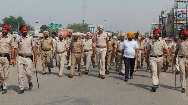 Police personnel taking out a march in Phagwara after a clash between Dalit and right-wing Hindu groups, on Saturday.(HT Photo)