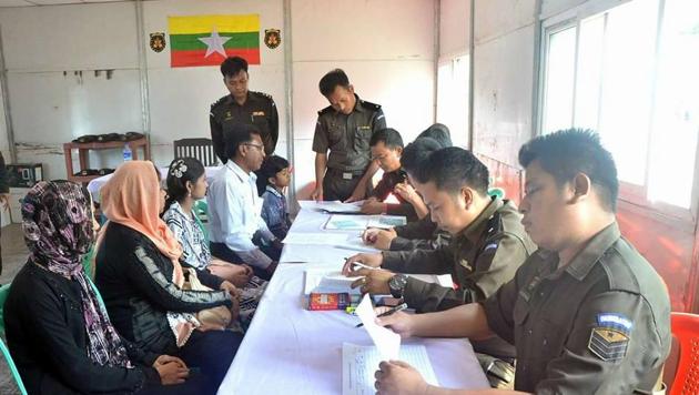 Photo posted alongside the Myanmar government’s statement shows one man, two women, a young girl and a boy receiving the ID cards.(Myanmar government’s Information Committee/ Facebook)