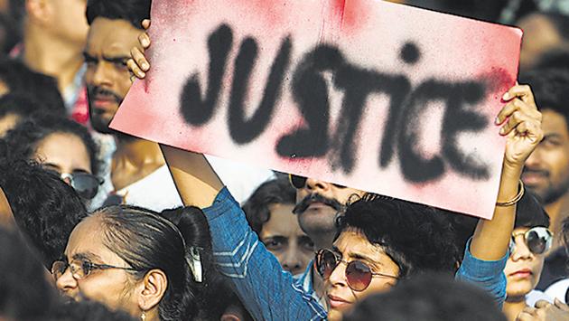 People hold placards as they participate in a protest against rapes in Mumbai on Sunday.(Satish Bate/HT Photo)