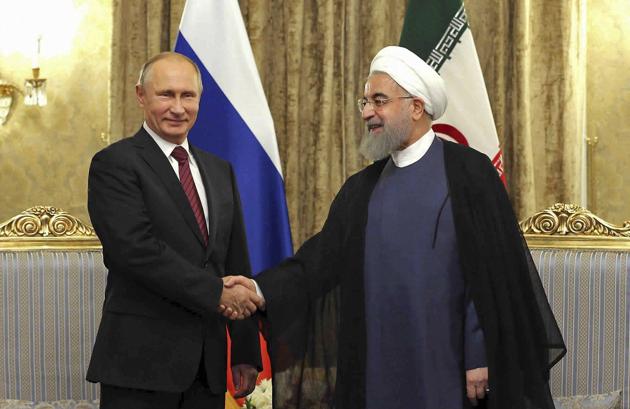 In this photo released by an official website of the office of the Iranian Presidency, Iran's President Hassan Rouhani, right, shakes hands with Russian President Vladimir Putin during their meeting at the Saadabad Palace in Tehran, Iran.(AP File Photo)