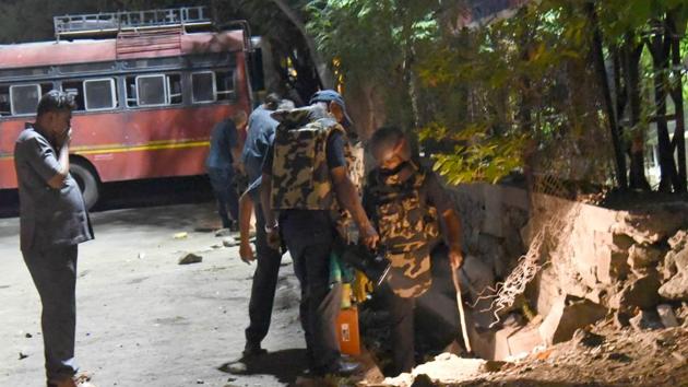 Bomb Detection And Disposal Squad (BDDS) team search the spot near Vallabhnagar ST stand for low intensity explosives in Pune.(HT PHOTO)