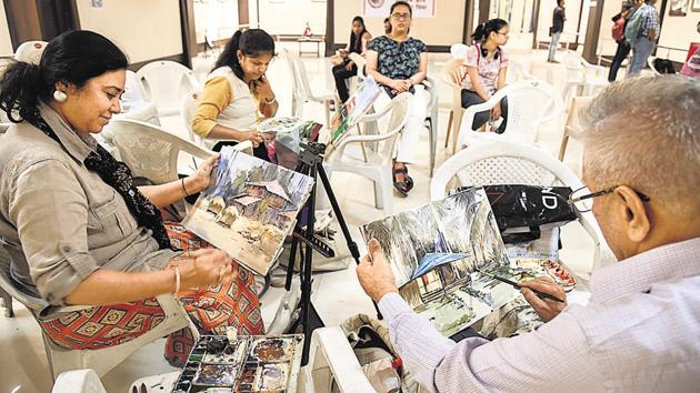 Artists engage in a live painting session at 23rd Nivasi Camp’s painting exhibition organised by the Sanskar Bharati group at the Balgandharva Rang Mandir on April 10.  (Sanket Wankhade/HT PHOTO) 