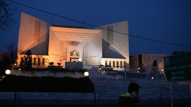 A Pakistani pedestrian walks past the Supreme Court building in Islamabad. Justice Ijaz ul Ahsan was given the responsibility to monitor the three corruption references against Nawaz Sharif and his children.(AFP File Photo)