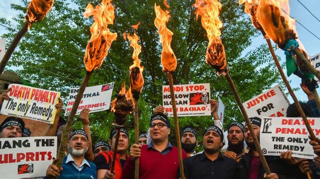 Members of RTI Movement and local residents display placards and hold torches during a protest against the rape and murder of 8-year-old girl of Kathua in Jammu, in Srinagar on Saturday.(PTI File Photo) Members of RTI Movement and local residents display placards and hold torches during a protest against the rape and murder of 8-year-old girl of Kathua in Jammu, in Srinagar on Saturday.(PTI File Photo)