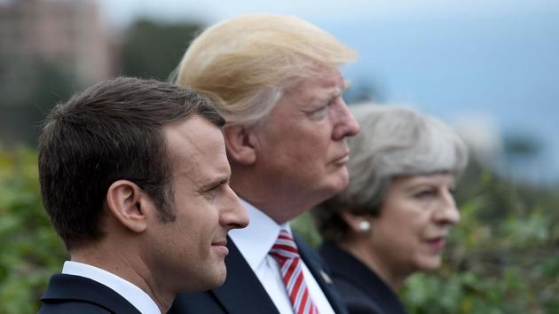 (FILES) This file photo taken on May 26, 2017 shows (L-R) French President Emmanuel Macron, US President Donald Trump and Britain's Prime Minister Theresa May attending the Summit of the Heads of State and of Government of the G7 plus the European Union in Taormina, Sicily. The US, Britain and France ordered overnight on April 14, 2018 a major military operation by deciding to conduct joint strikes against the Syrian regime of Bashar al-Assad in response to alleged chemical weapons attacks.(AFP)