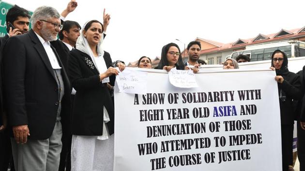 Kashmiri lawyers stand behind a banner during a protest calling for justice following the recent rape and murder case of an eight-year-old girl in Srinagar, on Monday.(AFP Photo)