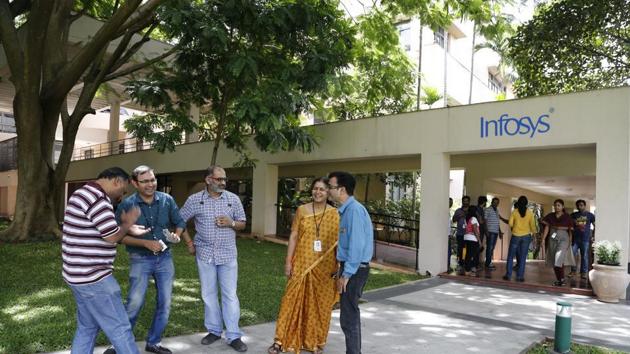 Infosys employees share a lighter moment during a break at the company headquarters in Bangalore, India.(AP Photo)