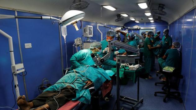 Doctors perform middle ear surgery in an operating theatre on the train. Decorated with mahogany flower garlands, the sky-blue train could be mistaken for a new passenger line. Inside, facilities could rival many public hospitals. It employs 20 permanent paramedic staff, with most doctors volunteering from nearby medical colleges or hospitals. (Danish Siddiqui / REUTERS) Doctors perform middle ear surgery in an operating theatre on the train. Decorated with mahogany flower garlands, the sky-blue train could be mistaken for a new passenger line. Inside, facilities could rival many public hospitals. It employs 20 permanent paramedic staff, with most doctors volunteering from nearby medical colleges or hospitals. (Danish Siddiqui / REUTERS)