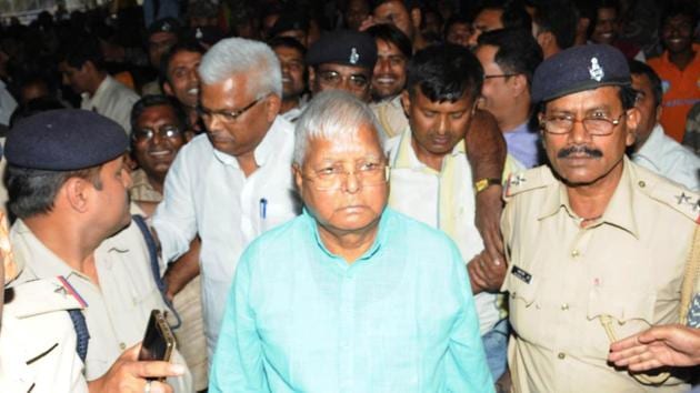 Convicted prisoner in a fodder scam RJD President Lalu Prasad with party workers at Ranchi railway station to board the New Delhi bound Rajdhani Express.(HT File Photo)