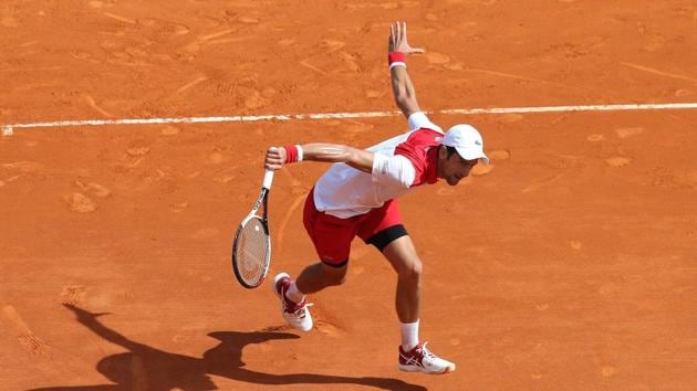 Novak Djokovic returns to Dusan Lajovic during their round of 64 tennis match at the Monte Carlo ATP Masters on Monday. (AFP) Novak Djokovic returns to Dusan Lajovic during their round of 64 tennis match at the Monte Carlo ATP Masters on Monday. (AFP)