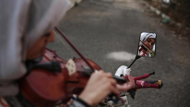 A music student is reflected in a mirror as she practices playing the violin during a music class. The conflict has killed more than 10,000 Yemenis and Saudi-led airstrikes have killed thousands of civilians and destroyed hospitals, schools and markets. (Hani Mohammed / AP) A music student is reflected in a mirror as she practices playing the violin during a music class. The conflict has killed more than 10,000 Yemenis and Saudi-led airstrikes have killed thousands of civilians and destroyed hospitals, schools and markets. (Hani Mohammed / AP)