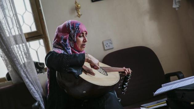 A female Yemeni music student practices playing Oud. As part of his “Learn Music For Free In Wartime” initiative, El-Deb’y gives students both theoretical and practical lessons. (Hani Mohammed / AP) A female Yemeni music student practices playing Oud. As part of his “Learn Music For Free In Wartime” initiative, El-Deb’y gives students both theoretical and practical lessons. (Hani Mohammed / AP)