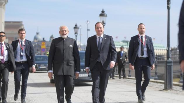 Prime Minister Narendra Modi and Sweden's Prime Minister Stefan Lofve walk from Sagerska House to the government building Rosenbad in Stockholm, Sweden,on Tuesday.(Reuters photo)