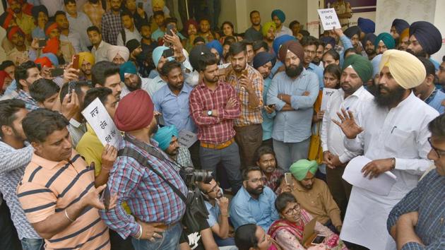 Lok Insaaf Party MLA Simarjeet Singh Bains interacting with agitating sewa kendra employees during a protest against non-payment of their salaries in Ludhiana on Monday.(Gurpreet Singh/HT)