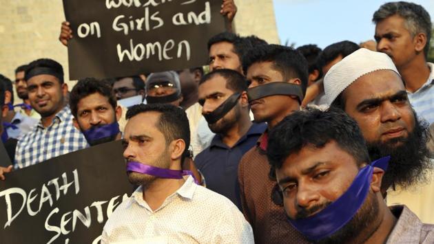 Men wear black and blue bands seeking an end to sexual violence against women, during a protest in Bangalore on April 16, 2018. (Aijaz Rahi / AP) 