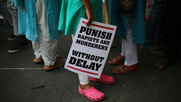 Protesters display placards during a protest against the two recently reported rape cases as they gather near the Parliament in New Delhi on April 15, 2018. Violent crimes against women have been on the rise in India despite tough laws enacted in 2013. (Oinam Anand / AP) 