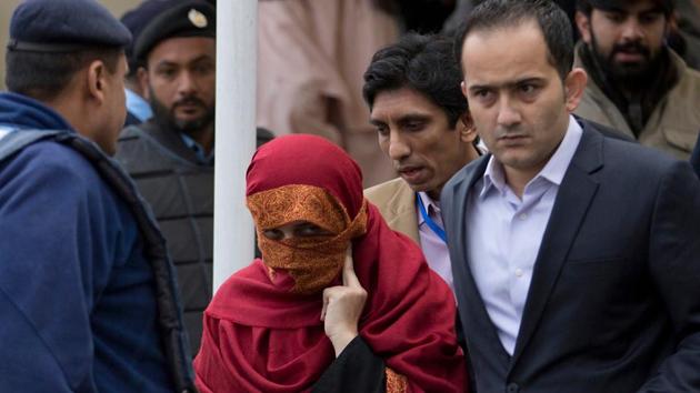In this January 6, 2017 photo, the wife, center, of a judge is escorted from the Supreme Court by her brother in Islamabad, Pakistan.(AP File Photo)