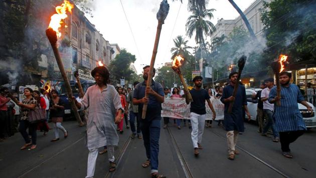 A group of agitated people took out a rally with lit torches protesting against the rape and murder of the eight-year-old girl in Kathua, in Kolkata on April 16. The girl belonged to nomadic Bakarwal community and was abducted on January 10. According to the chargesheet she was held captive in a temple, sedated and assaulted repeatedly. (Rupak De Chowdhuri / REUTERS) 
